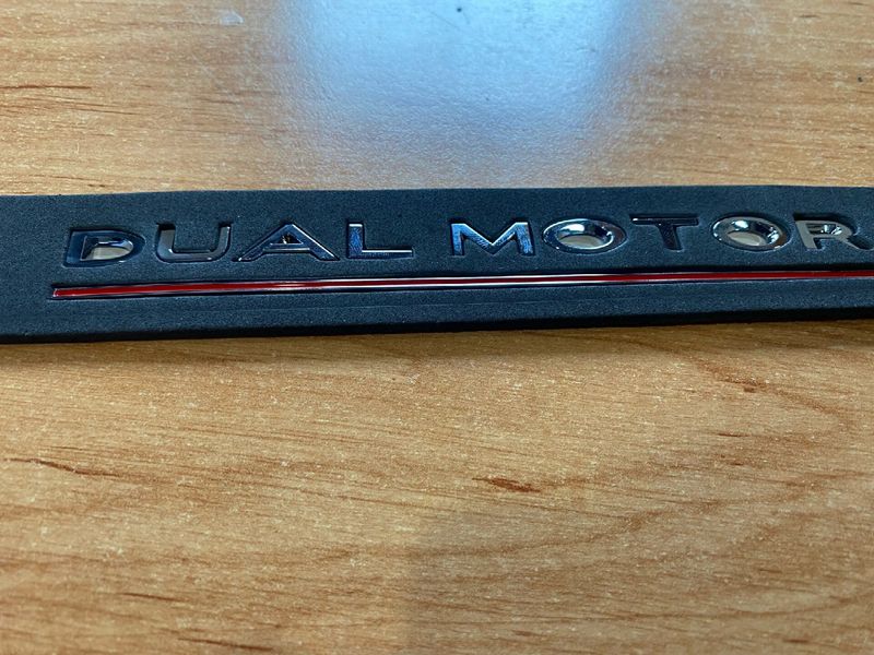 1484849-00-B "DUAL MOTOR PERFORMANCE" emblem on the trunk lid of Tesla Model 3, SR, X, Y photo